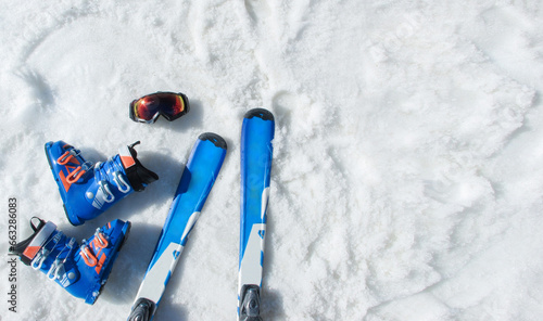Mountain skis, sunscreen mask, ski goggles and ski boots on bright alpine snow. Winter holidays.  Extreme sport. Vacation, travel content. Copy space photo