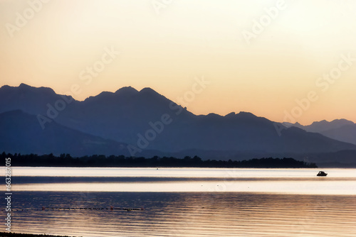 impression of lake chiemsee with golden shining light at the evening