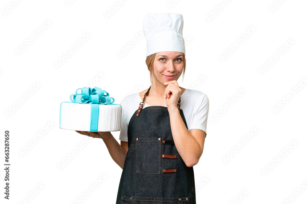 Young pastry blonde woman with a big cake over isolated chroma key background thinking Young pastry blonde woman with a big cake over isolated chroma key background thinking