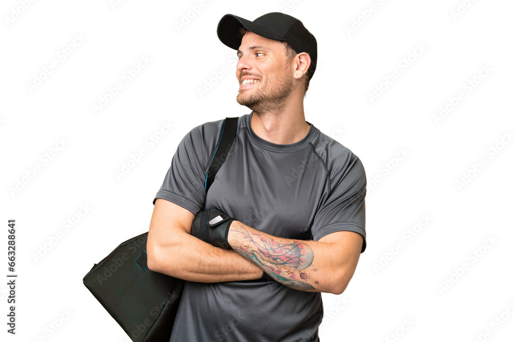 Young sport man with sport bag over isolated chroma key background looking side Young sport man with sport bag over isolated chroma key background looking side