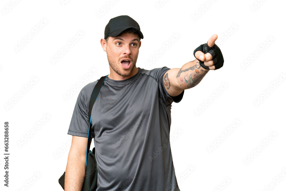 Young sport man with sport bag over isolated chroma key background pointing away Young sport man with sport bag over isolated chroma key background pointing away