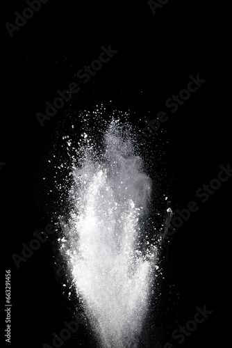 White powder explosion on black background. Colored cloud. Color dust explode. Paint Holi.