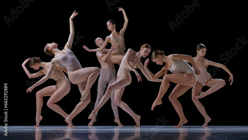 Tenderness and grace. Group of talented young people, elegant ballet dancers making performance against black background. Concept of classical and modern dance, beauty, creativity, art, theater