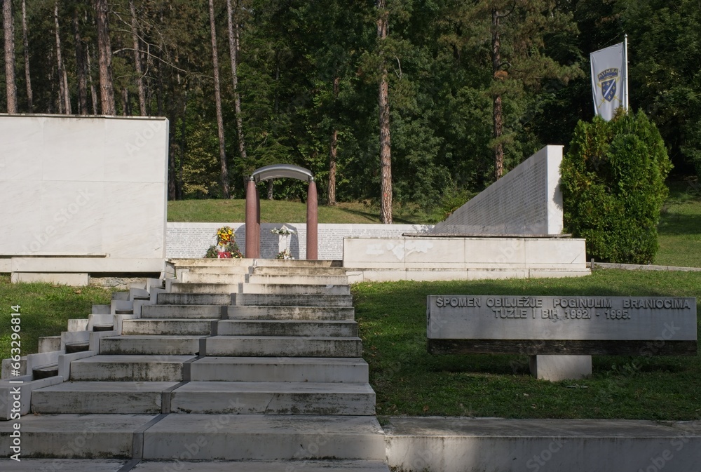 Tuzla, Bosnia and Herzegovina - Oct 4, 2023: This Slana Banja memorial complex remembers Tuzla residents killed or missing during the Bosnian War. Sunny autumn day. Selective focus.
