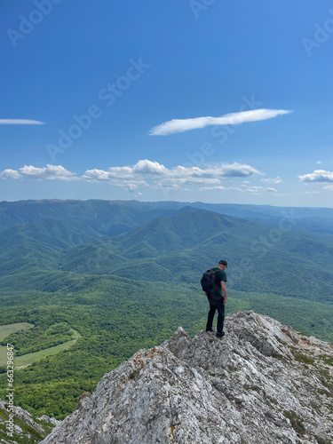 a man standing on a mountain hiking journey nature hike