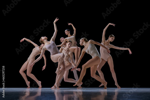 Tender, elegant young people, ballet dancers making beautiful performance on stage against black background. Concept of classical and modern dance, beauty, creativity, art, theater