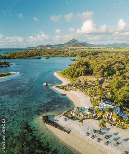 Aerial view of a beautiful beach along the coast with mountain in background in Ilot Lievres, Flacq, Mauritius. photo