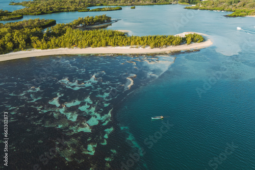 Aerial view of a fishing boat along the coastline of Ilot Mangenie island, Ilot Lievres, Flacq, Mauritius. photo