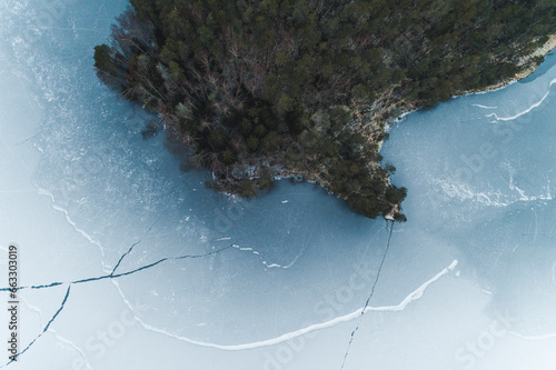 Aerial view of white frozen Jussi lake with abstract ice cracks in early winter, Pohja-Korvemaa Nature Reserve, Harjumaa, Estonia. photo