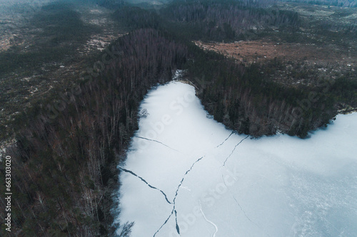 Aerial view of white frozen Jussi lake with abstract ice cracks in early winter, Pohja-Korvemaa Nature Reserve, Harjumaa, Estonia. photo