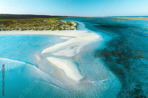 Aerial view of a woman on the beach at Turquoise Bay, Exmount, Western Australia. photo