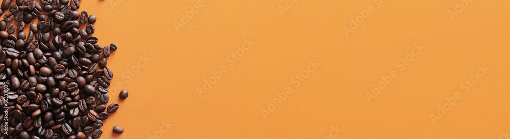 Fototapeta premium Roasted coffee beans on orange background, top view. Pile of halves of dark brown coffee beans, copy space