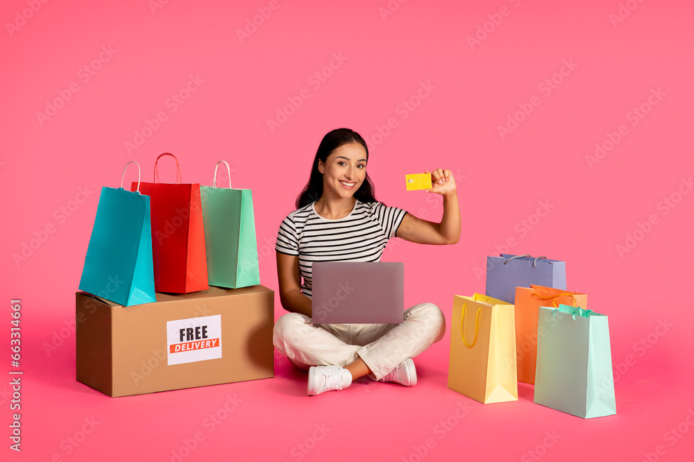 Internet Purchases. Smiling Woman Using Laptop And Credit Card For Online Shopping
