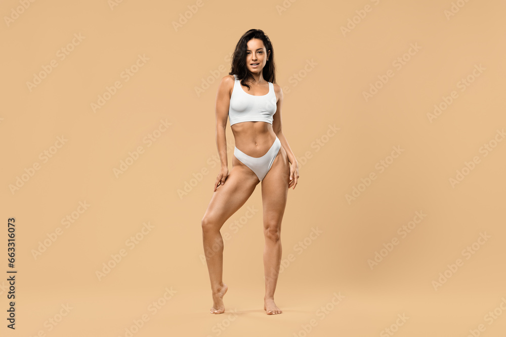 Sexy Young Beautiful Woman In White Underwear Posing Over Beige Studio Background Sexy Young Beautiful Woman In White Underwear Posing Over Beige Studio Background