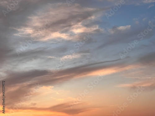 Natural background sky. Blue sky with clouds and sun. Cirrus Clouds Painting the Sky in Gentle Hues. Blue sky with clouds © AlexGo
