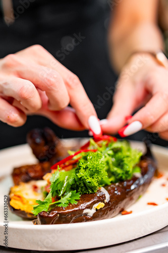 chef Cooking baked eggplant at the restaurant kitchen