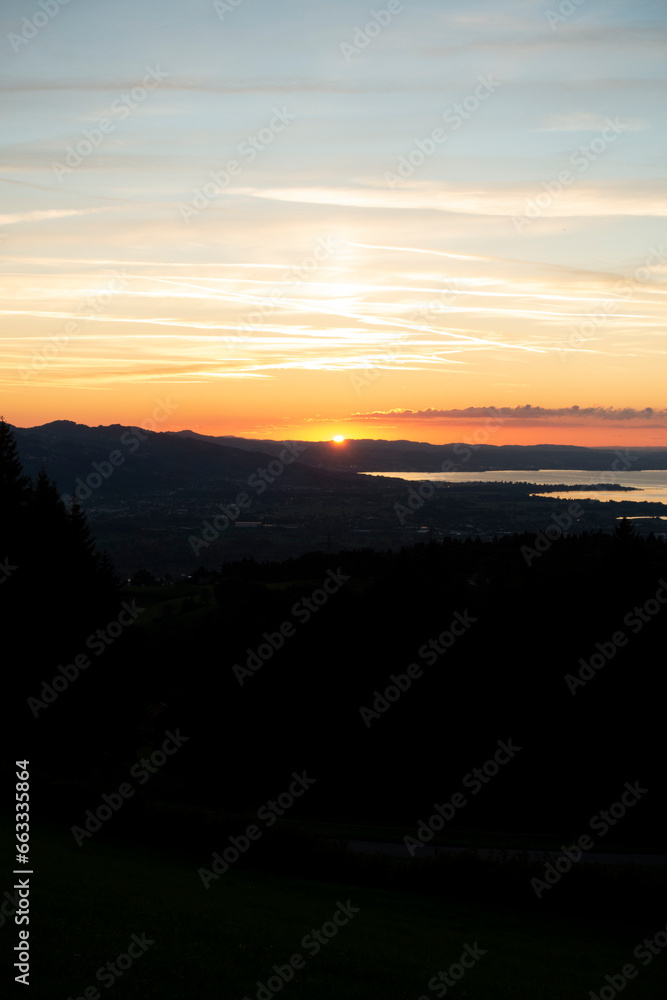 sunset over the lake in the golden hour seen from a mountain