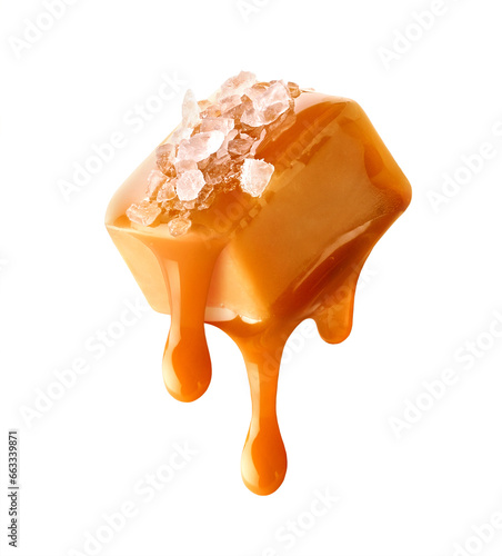 Flying salty caramel candy topped with salt crystals and pouring caramel sauce