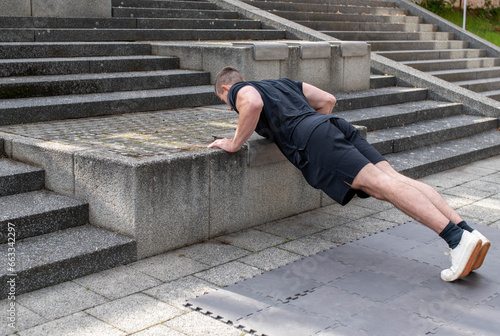 Incline push-up doing by a young athletic man. Push-up modification for beginners photo