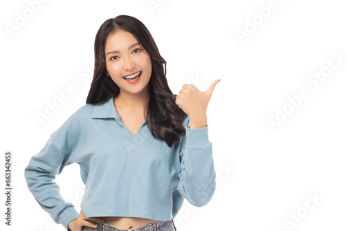 Beautiful young Asian woman pointing up to copy space and looking at camera with smile face and happy Pretty girl act like a satisfied product, use for advertising with isolated on white background