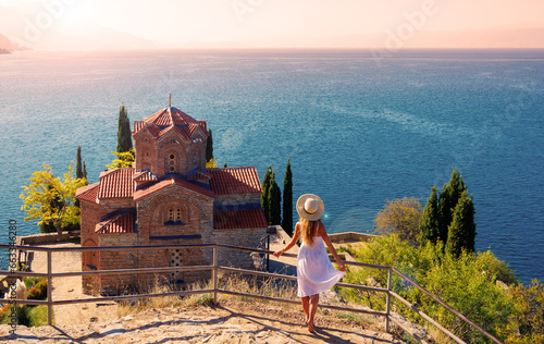 Photos Young female in white dress and hat enjoying panoramic view of famous church,  O
