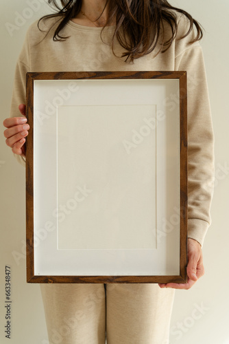 Female hanging wooden frame with empty mockup copy space