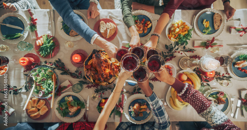 Photography Parents, Children and Friends Enjoying Christmas Dinner Together in a Cozy Home