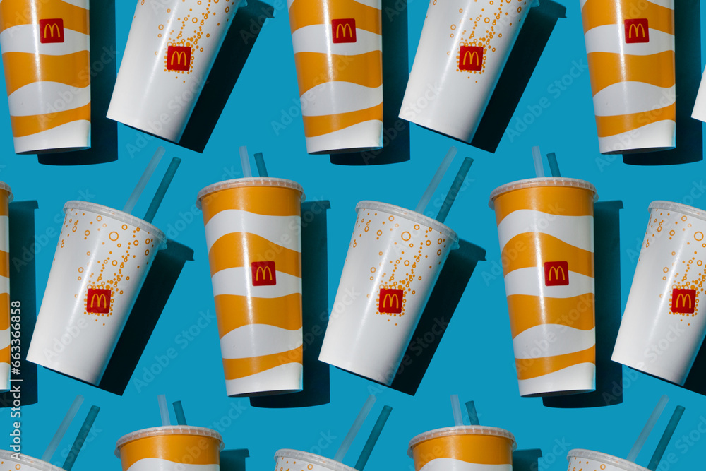 Yellow glass of McDonald's. Paper cup with lid. Takeaway drink ...