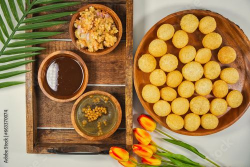 Gourmet Delight: Vibrant Pani Puri, India's Irresistible Street Food Sensation. The golden, crispy puris filled with a delightful spiced potatoes, chickpeas, and tamarind chutney. With aromatic paani photo