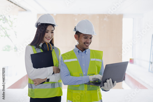 Two engineer using laptop computer with project planning in congratulations.