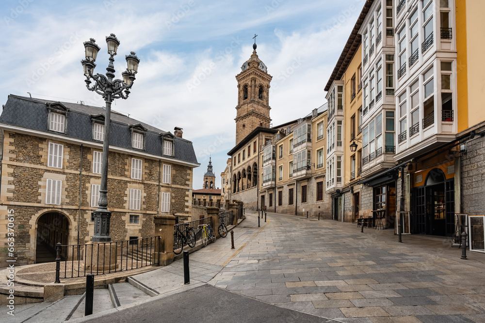 Alley with historic buildings and old church tower in the monumental city of Vitoria, Spain.