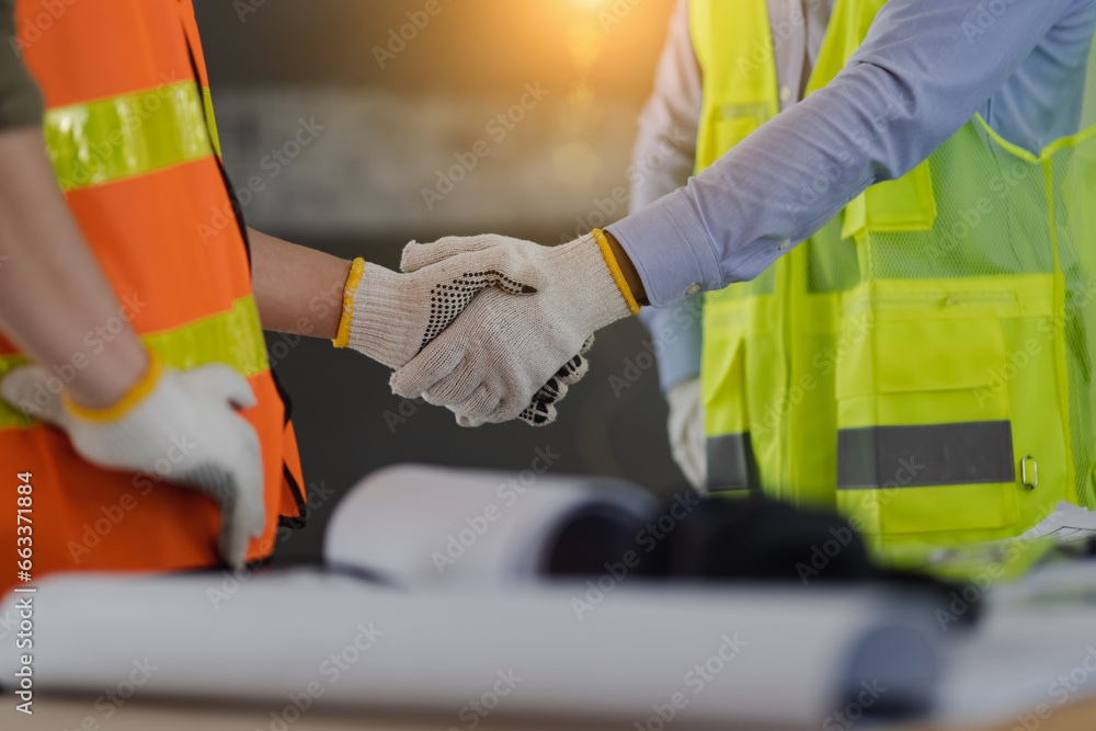 Two engineer shaking hands with project planning and congratulations. Two engineer shaking hands with project planning and congratulations.
