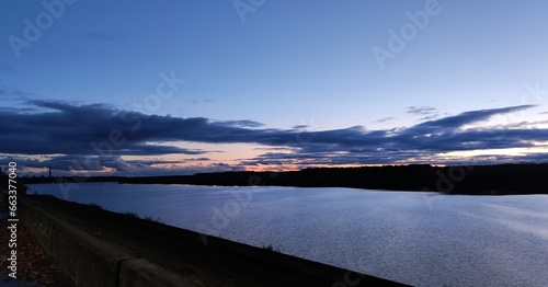 Sunset on the river surrounded by trees