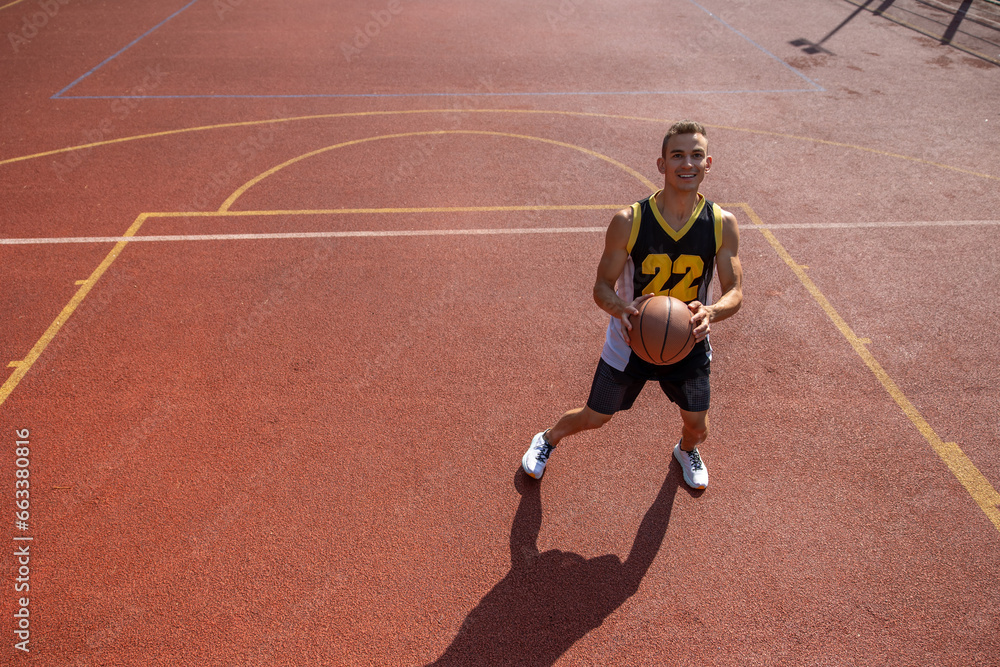Male sportsman playing basketball throwing ball at playground. Male sportsman playing basketball throwing ball at playground.