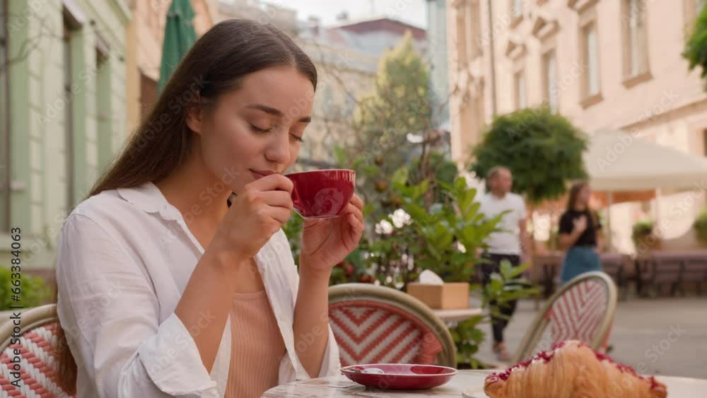 Smiling European girl woman tourist enjoying breakfast hot coffee croissant in city cafe terrace Caucasian lady female smelling aroma drink pleasure weekend in restaurant morning relaxing outdoors Smiling European girl woman tourist enjoying breakfast hot coffee croissant in city cafe terrace Caucasian lady female smelling aroma drink pleasure weekend in restaurant morning relaxing outdoors