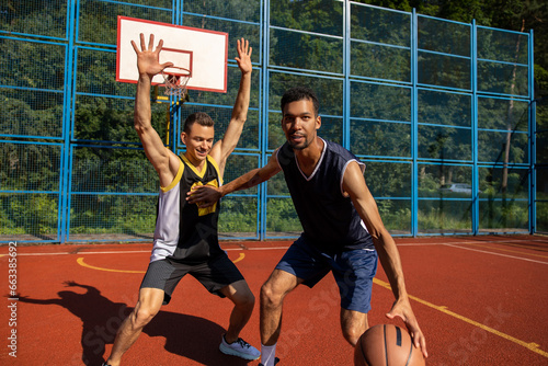 Street basketball players having training outdoor at court. photo