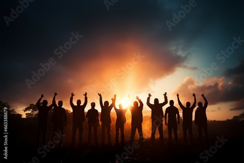 Silhouetted hands join, a teams happiness fills the air