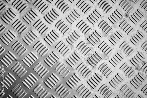 Dirty diamond plate, checker plate, cross hatch kick plate seamless metal sheet texture.