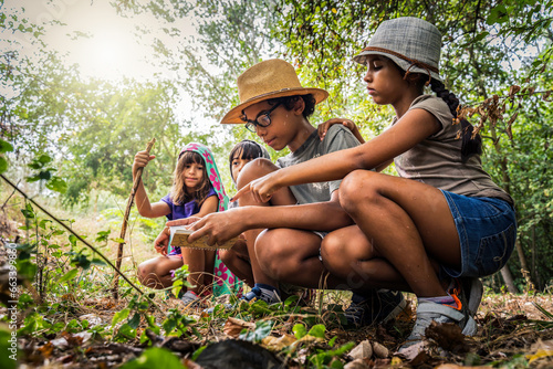 Принти на полотні Multiethnic group of curious happy school kids in casual clothes exploring natur
