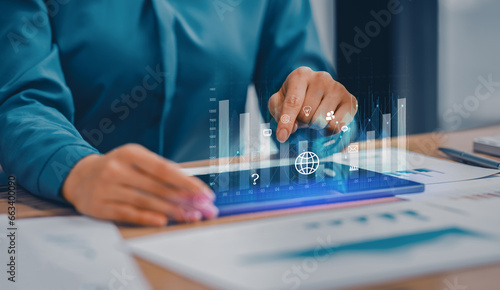 Technology and financial advisory services concept. Business woman hands working on digital tablet computer with advisor showing plan of investment to clients at table office. Digital marketing.