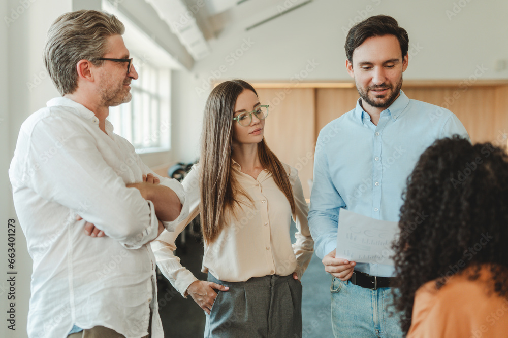 Obraz premium Confident positive businesspeople, students, managers standing, talking, working in modern office