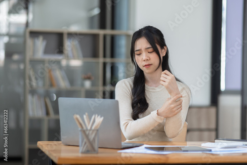 Asian businesswoman are stressed and tired from work sitting at desk in the office, feeling sick at work, stress from work. 