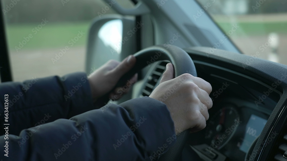 Close-up hand holding truck steering wheel driving on road Close-up hand holding truck steering wheel driving on road