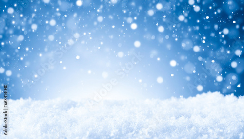 Winter and snow storm with blue sky and snowflakes in bokeh soft light abstract background with white light in the middle. Copy space for text.