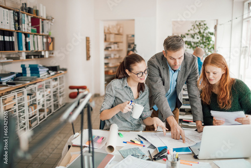 Fotografie Diverse trio of architects working on building design in a modern office