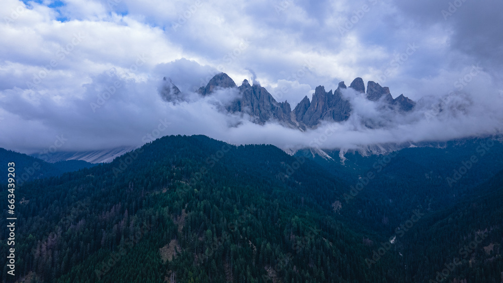 Aerial view of the Italian Dolomites at Saint Magdalena, on a rainy day. Photography was shot from a drone at a higher altitude with the beautiful Dolomites in the background.