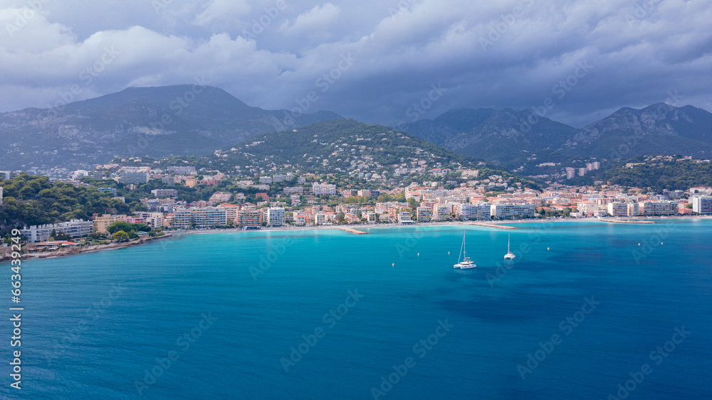 Aerial view of The French Riviera at Menton, France. Photography was shoot from a drone at a higher altitude from above the bay with the city and the mountains in the background on a stormy weather.