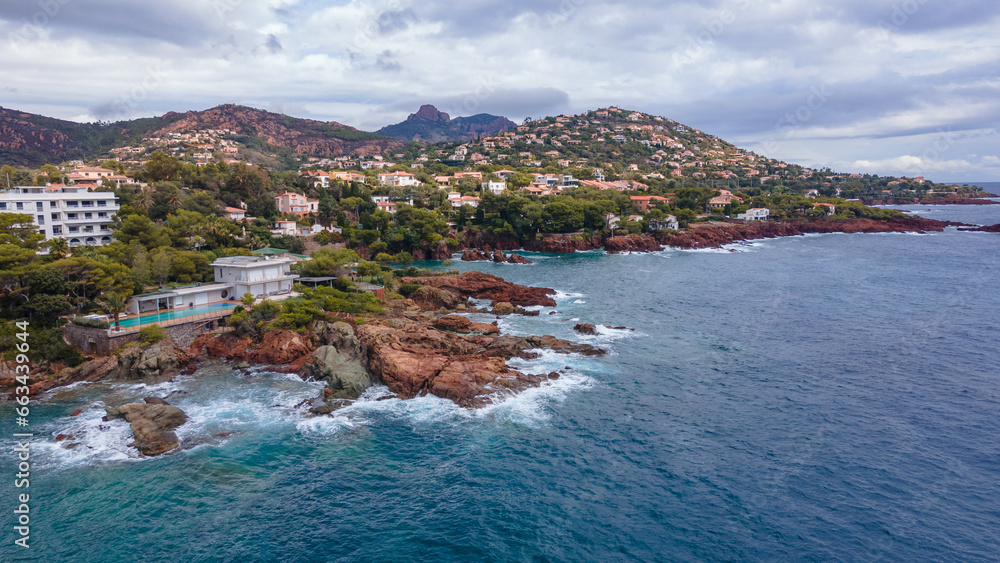 Aerial video of the Agay bay on the French Riviera. In the photography can be seen Agay lighthouse and a panorama of the bay, with mountains in the background. Photography was shot on a cloudy day.