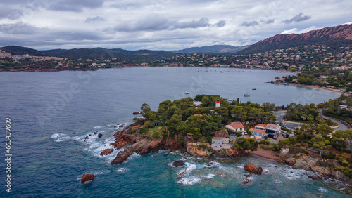 Aerial video of the Agay bay on the French Riviera. In the photography can be seen Agay lighthouse and a panorama of the bay, with mountains in the background. Photography was shot on a cloudy day.