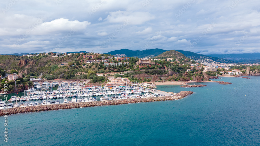 Aerial view of Mount Turnei, located on the French Riviera. Photography was shot from a drone at a higher altitude from above the water wit the beautiful marina and beach in the view.